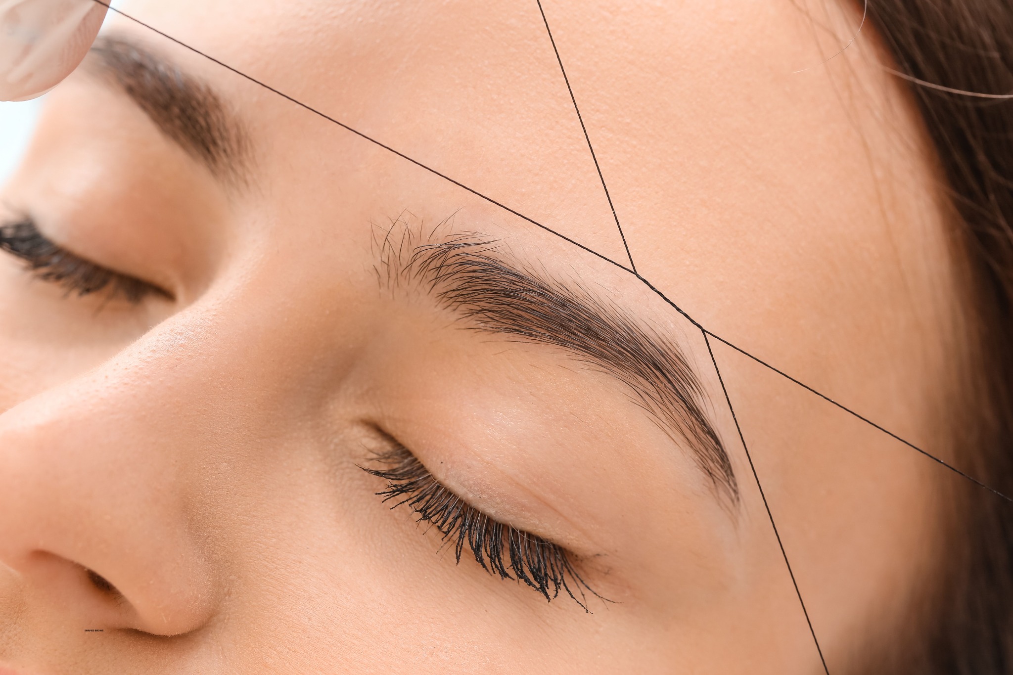 Clear view of eyebrow threading in progress