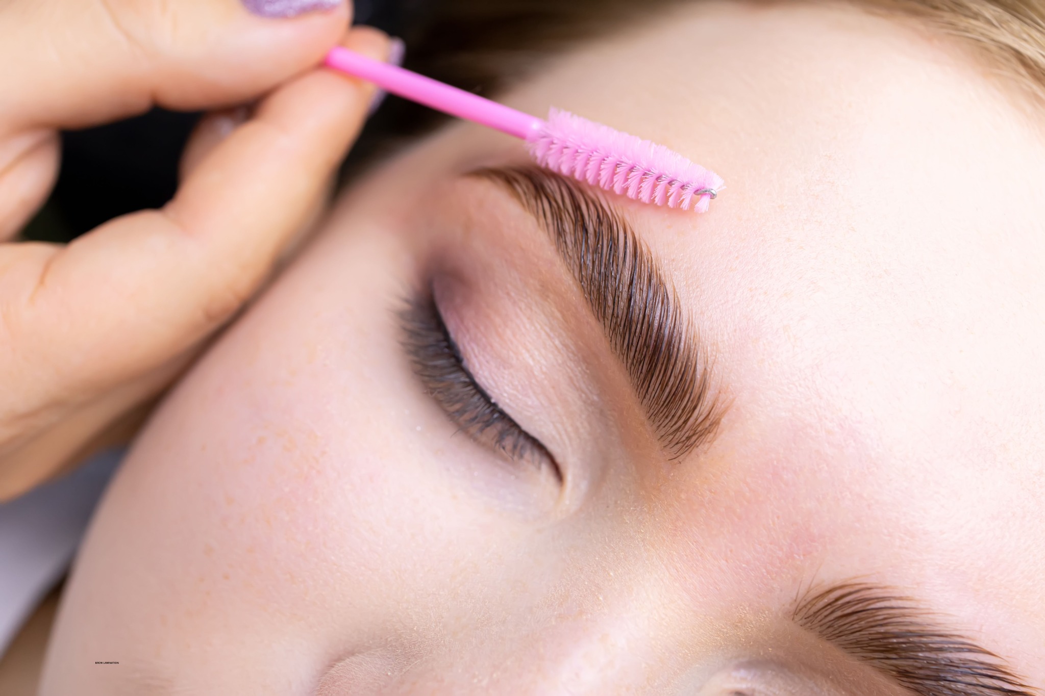 Brow lamination treatment creating a smooth, lifted brow appearance