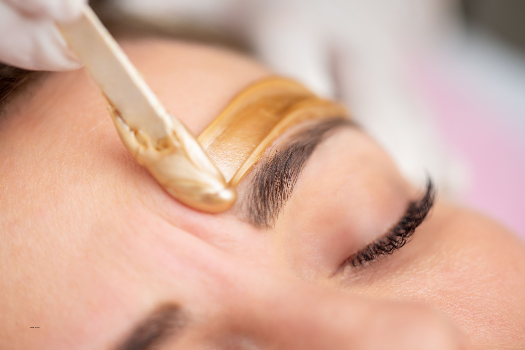 Professional facial waxing service in progress